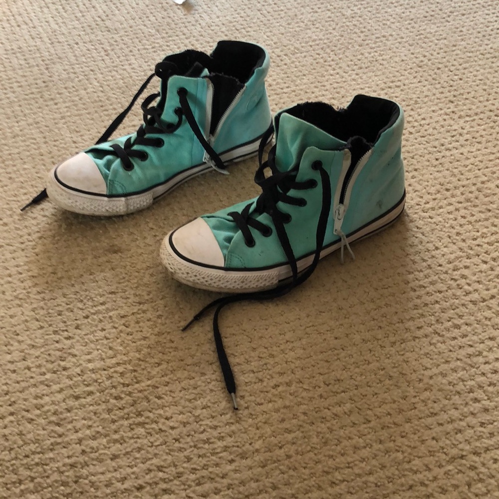 Teal coloured converse high tops